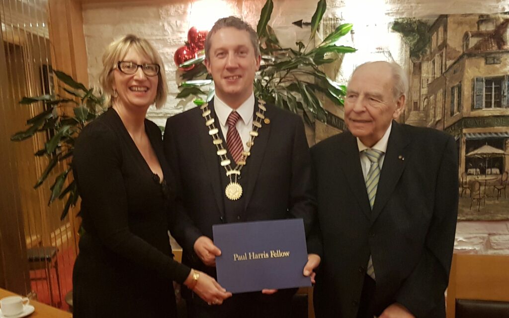 President Niall Reck, being Presented with the Paul Harris Award Bu Jurgen Sassmanhaussen and Vice President Maura Bell