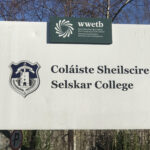 Selskar College Logo and WWETB logo on exterior sign with trees in the background.