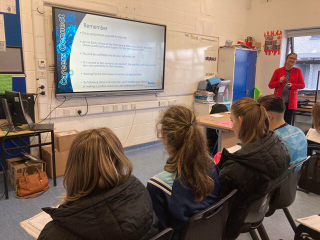 Member of the Rotary Club delivering talk to students on starting a new job.