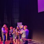 Students participating in a demonstration on stage at the Just 1 Life programme.